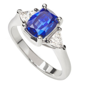 The Lyric Ring - Cushion shape Sapphire with trilliant diamond sides in platinum from The Brown Goldsmiths Signature Ring Collection