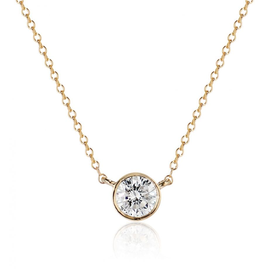 diamond bezel pendant necklace with a round brilliant diamond 0.70ct in 14k yellow gold attached to a cable chain that can be worn at both 16 & 18 inches long.