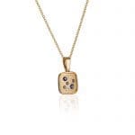 A galaxy of Diamonds and natural blue Sapphires sparkle in this 14K gold Brown Goldsmiths original cushion shaped pendant.