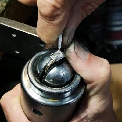 masculin hands creating bespoke fine jewelry diamond ring