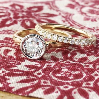 Floating Diamond Ring with shared prong diamond band BG Social Media Red patterned fabric