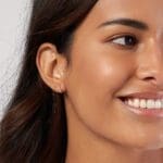 Diamond 10mm Huggie Hoops 14k yellow gold on a model