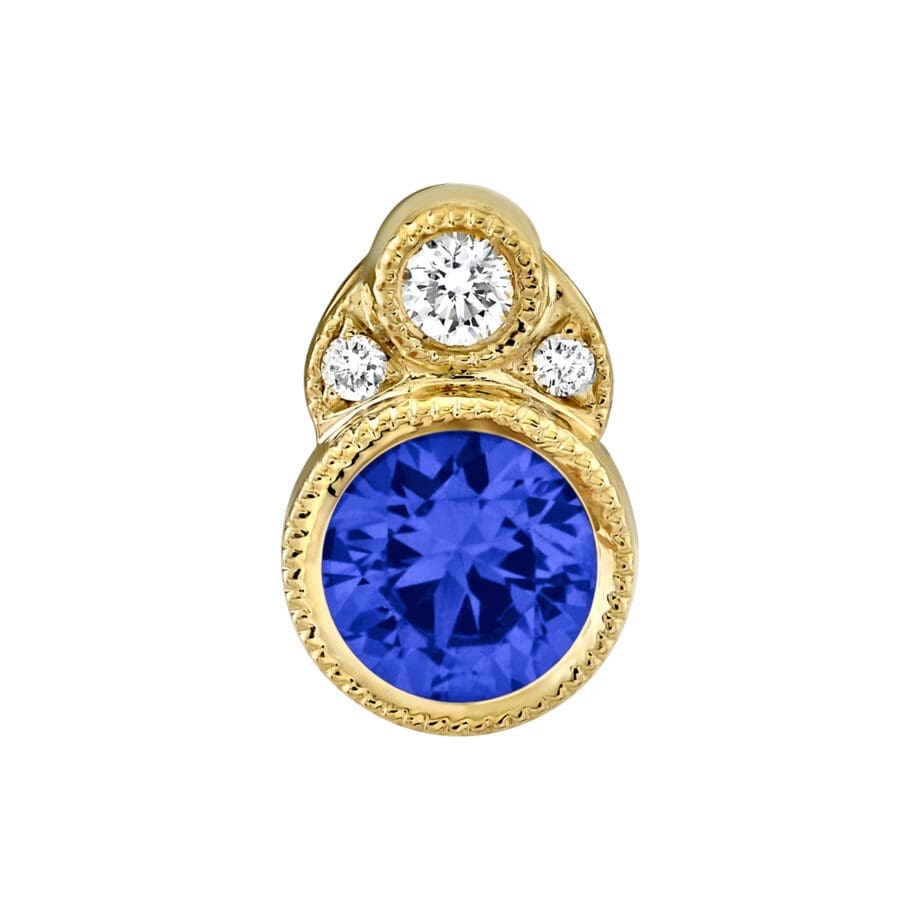Blue Sapphire Pendant bezel set with a milgrain edge in 14kt Yellow Gold with three Diamonds at the top.