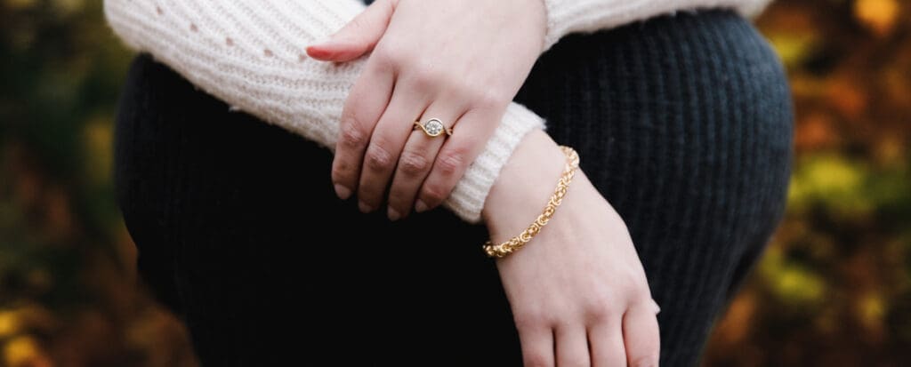Arms crossed with bracelet and ring