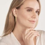 Triple Snake Chain Earrings yellow gold post earrings. On a model