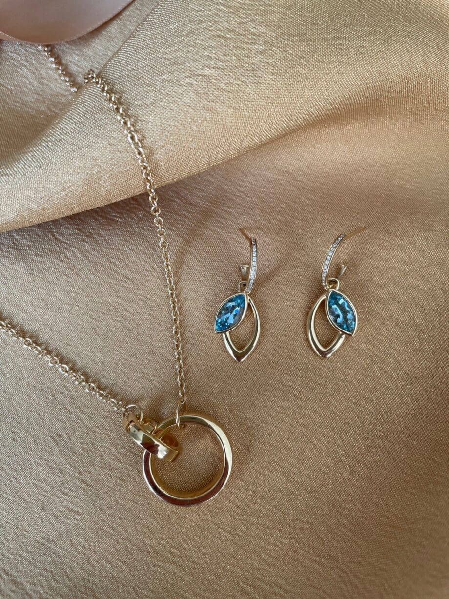 Modern Aquamarine Dangle Earrings shown with the wedding band necklace.