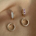 Beaded diamond Huggie hoops shown with a ruby and diamond pair.