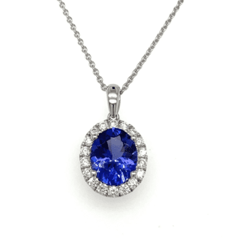 Tanzanite and diamond necklace white gold with oval tanzanite and diamond halo with plain bail and cable chain 17" long.