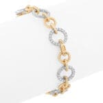 Two-tone gold diamond link bracelet with twisted rope detailing and round diamond links - on round form