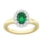 Oval emerald halo ring in 18K two-tone gold with yellow gold band and diamonds, size 6.5.