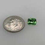 Tsavorite Cushion Cut loose with dime for scale