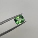 Tsavorite Garnet Cushion Cut loose in tweezers