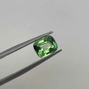 Tsavorite Garnet Cushion Cut loose in tweezers