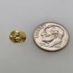 Yellow Zircon oval loose with dime for scale
