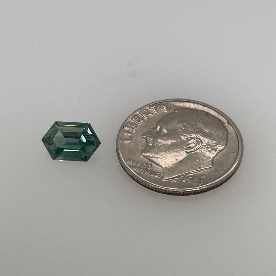 Teal Sapphire Hexagon 270-1282 loose with dime for scale