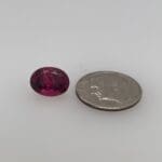 Rubellite Maine Tourmaline loose oval with a dime for scale.