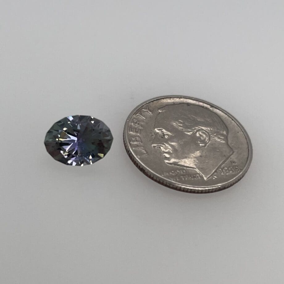Tanzanite oval loose with a dime for scale
