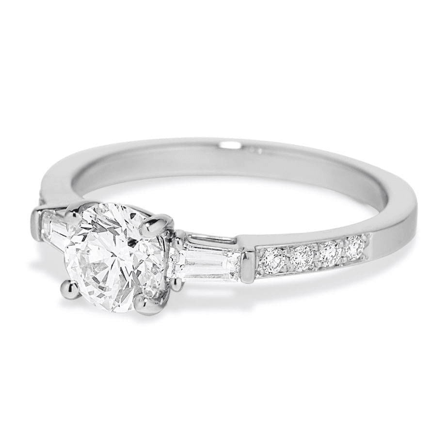 Platinum diamond engagement ring with round center and baguette side diamonds