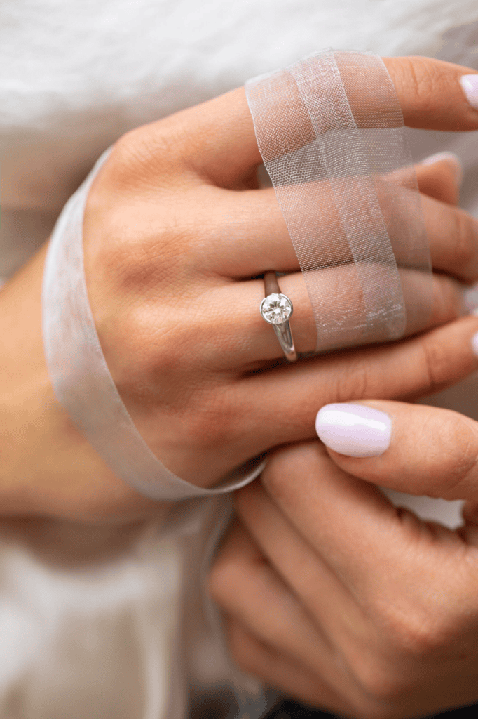 Partial bezel set solitaire engagement ring with 1.01ct round diamond in platinum
