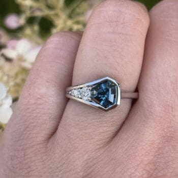 Geo ring with teal sapphire center and trilliant cut accents in 14K white gold, size 6.5