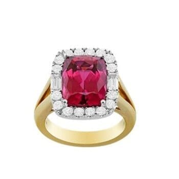 Elongated cushion-cut rubellite halo ring with diamond accents set in two-tone gold