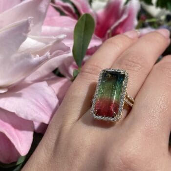 Halo ring with watermelon tourmaline center gemstone and emerald cut diamonds in 18K yellow gold, size 7.25
