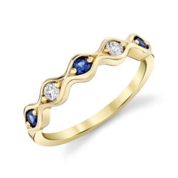 Anniversary ring with blue sapphire center and round diamond accents in 14K yellow gold
