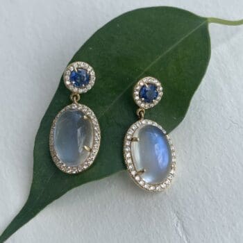 Moonstone and blue sapphire drop halo earrings in 14K yellow gold with post dangles