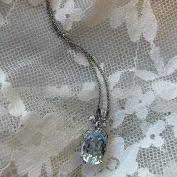 Aquamarine drop necklace with light blue center gem and pear-shaped diamonds in 14K white gold