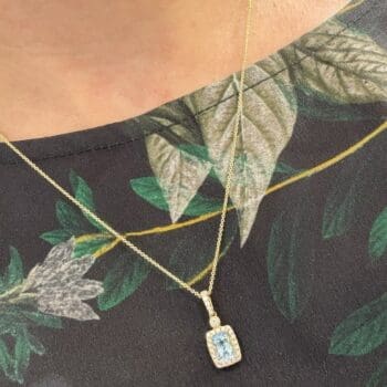 Aquamarine necklace with elongated cushion cut diamonds set in 14K yellow gold