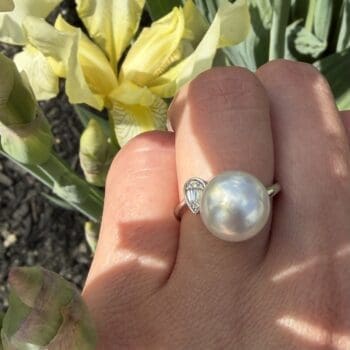 14K white gold ring featuring a 10.95mm South Sea pearl and pear-shaped diamond cluster