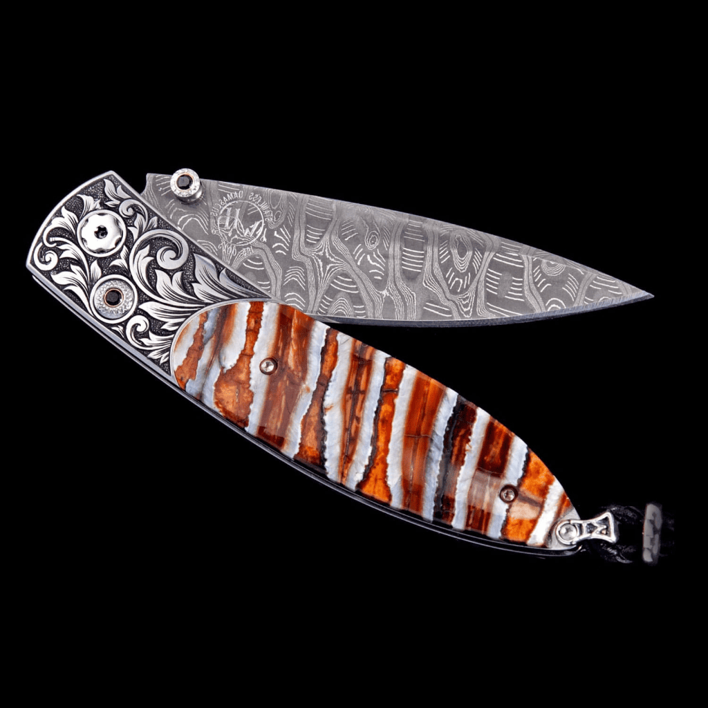 Jackson Monarch folding knife featuring hand-engraved stainless steel frame and fossil Woolly Mammoth tooth handle with damascus steel blade